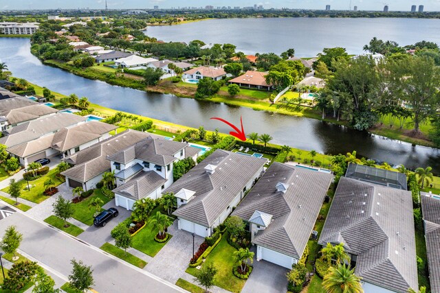 aerial view of residential area featuring a large body of water