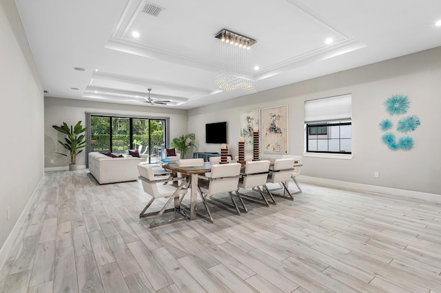 dining area with a tray ceiling, light wood-style floors, baseboards, and recessed lighting