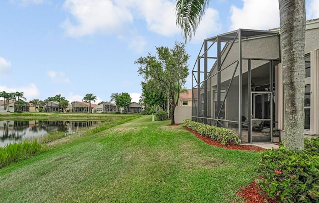 view of yard featuring a water view, a residential view, and a lanai