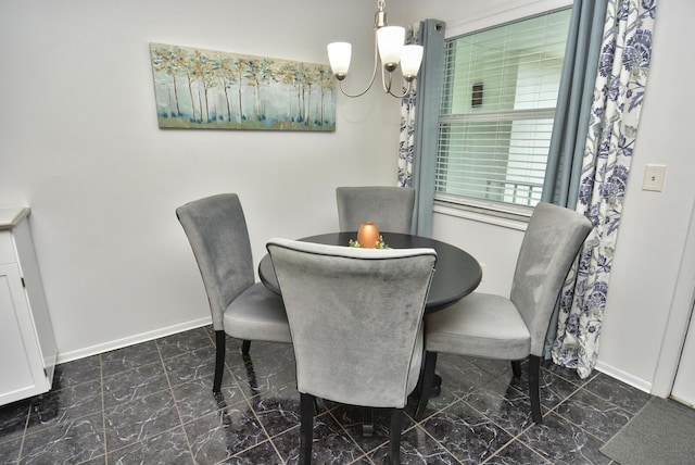 dining space with baseboards, marble finish floor, and an inviting chandelier