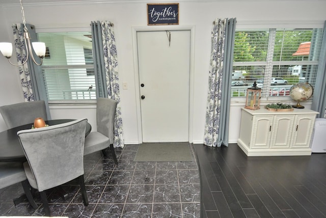 entryway with baseboards and a notable chandelier