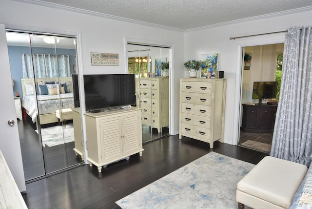 interior space featuring dark wood-style flooring, crown molding, and a textured ceiling