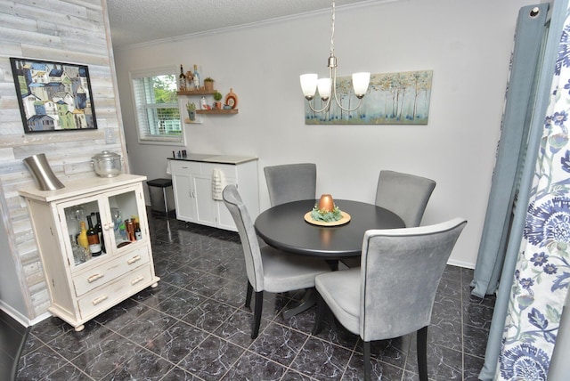 dining area with a notable chandelier, crown molding, a textured ceiling, wooden walls, and marble finish floor