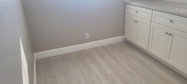 interior details featuring baseboards and wood finished floors