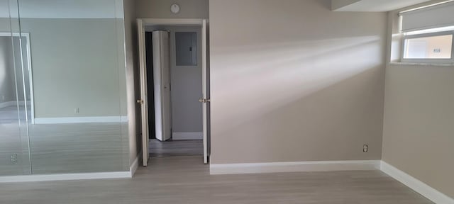 unfurnished room with baseboards and wood finished floors
