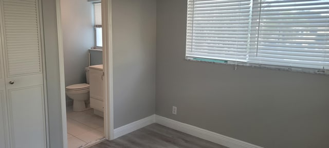 bathroom featuring vanity, baseboards, and toilet