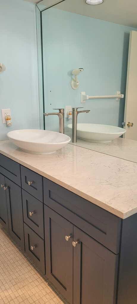 bathroom with tile patterned floors and vanity