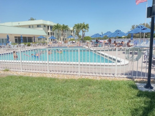 community pool featuring a patio area and fence