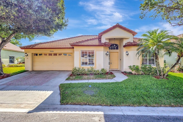7026 Galleon Cv, Riviera Beach, FL 33418 - mediterranean / spanish-style home featuring stucco siding, driveway, a garage, a tiled roof, and a front lawn
