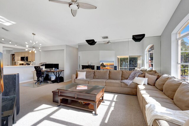 7026 Galleon Cv, Riviera Beach, FL 33418 - living room featuring a ceiling fan, light colored carpet, a chandelier, rail lighting, and baseboards