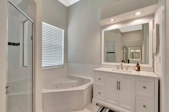 bathroom featuring vanity, a whirlpool tub, a stall shower, and recessed lighting