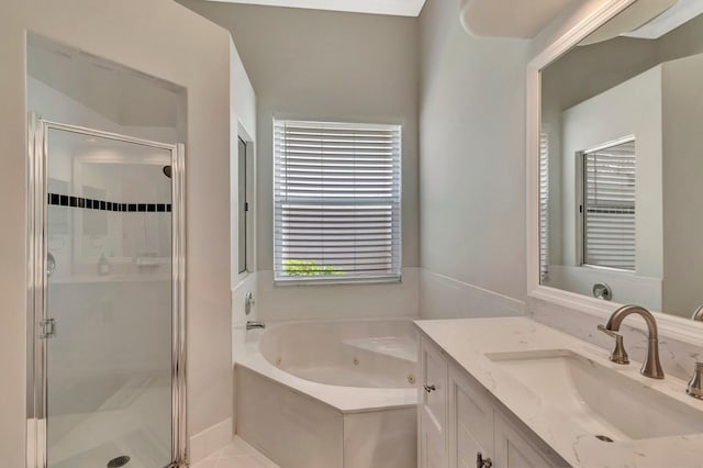 bathroom featuring a stall shower, a tub with jets, and vanity