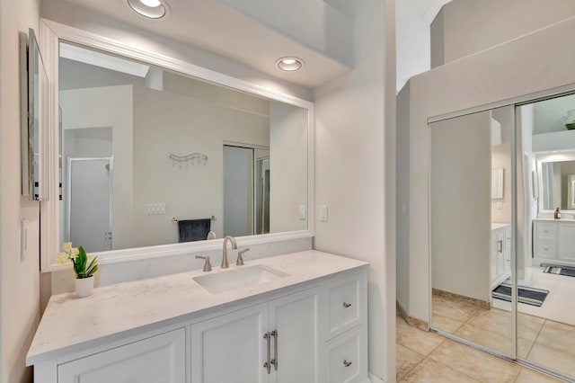 full bathroom featuring tile patterned floors, a stall shower, vanity, and recessed lighting