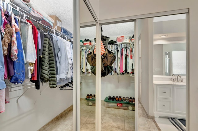 walk in closet featuring light tile patterned floors
