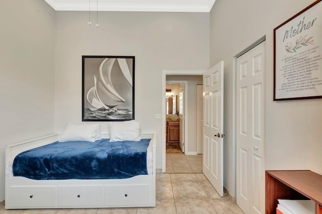 bedroom with light tile patterned floors and crown molding