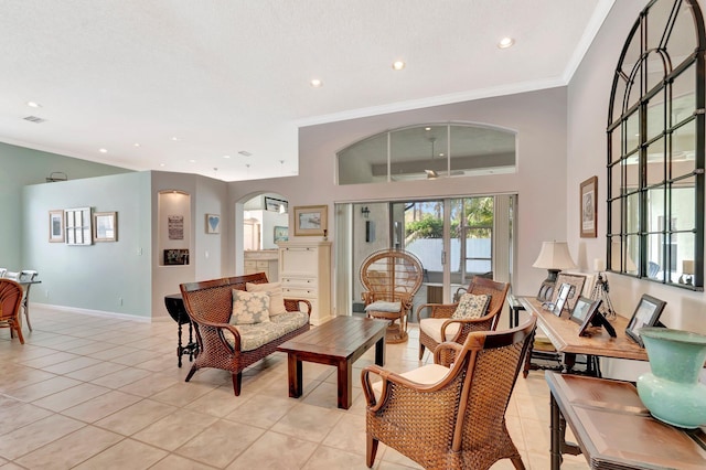 living room with recessed lighting, crown molding, arched walkways, light tile patterned floors, and baseboards