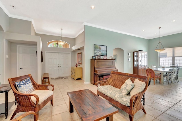 interior space with arched walkways, ornamental molding, and plenty of natural light