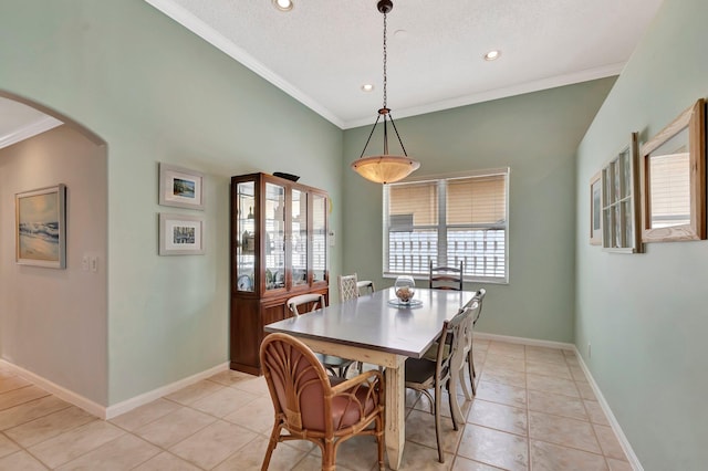dining room featuring arched walkways, a wealth of natural light, recessed lighting, and crown molding