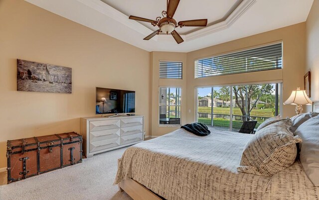 carpeted bedroom with access to outside, a raised ceiling, a towering ceiling, ceiling fan, and baseboards