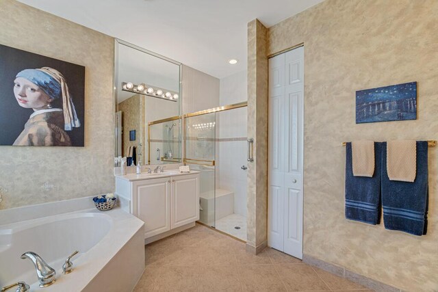 full bathroom with a shower stall, a bath, tile patterned floors, and vanity