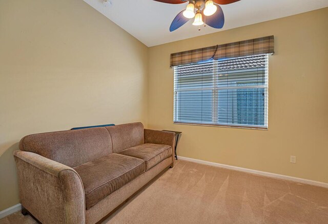 living area featuring baseboards, a ceiling fan, and carpet flooring