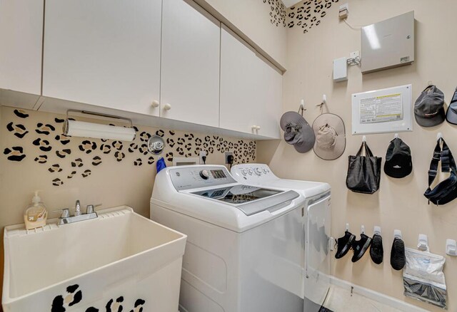 laundry room featuring washer and clothes dryer and cabinet space