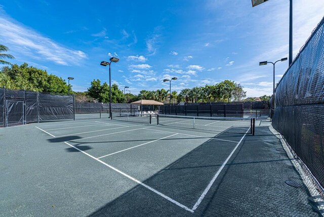 view of tennis court with fence