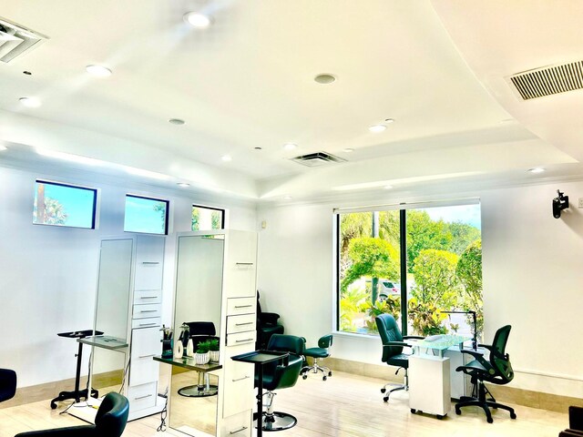 office featuring a raised ceiling, recessed lighting, wood finished floors, and baseboards