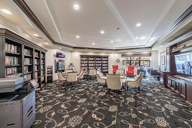 carpeted dining area with ornamental molding, a raised ceiling, and recessed lighting