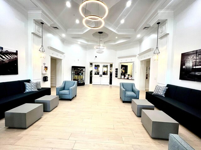 building lobby with a high ceiling, coffered ceiling, ornamental molding, and recessed lighting