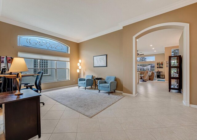 office area featuring arched walkways, ornamental molding, light tile patterned flooring, and baseboards
