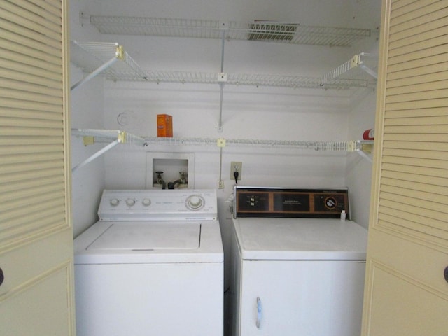clothes washing area with laundry area and washer and clothes dryer