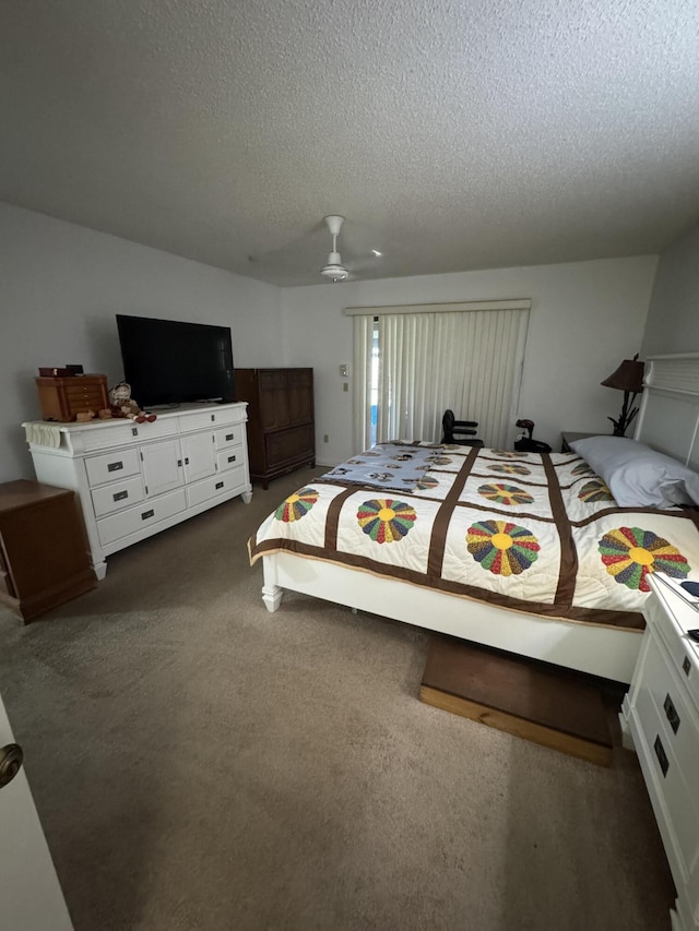 bedroom featuring ceiling fan, a textured ceiling, and dark carpet