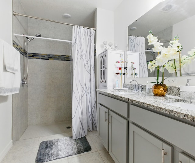 3020 SW Ann Arbor Rd, Port Saint Lucie, FL 34953 - bathroom featuring a tile shower, double vanity, and tile patterned floors