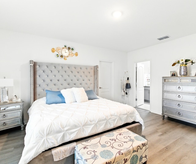 3020 SW Ann Arbor Rd, Port Saint Lucie, FL 34953 - bedroom featuring wood finished floors and ensuite bathroom
