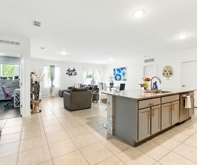 3020 SW Ann Arbor Rd, Port Saint Lucie, FL 34953 - kitchen with a sink, stainless steel dishwasher, light tile patterned floors, light stone counters, and gray cabinetry