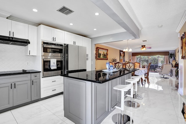5730 Fernley Dr E Unit 15, West Palm Beach, FL 33415 - kitchen featuring fridge, marble finish floor, visible vents, stainless steel double oven, and crown molding