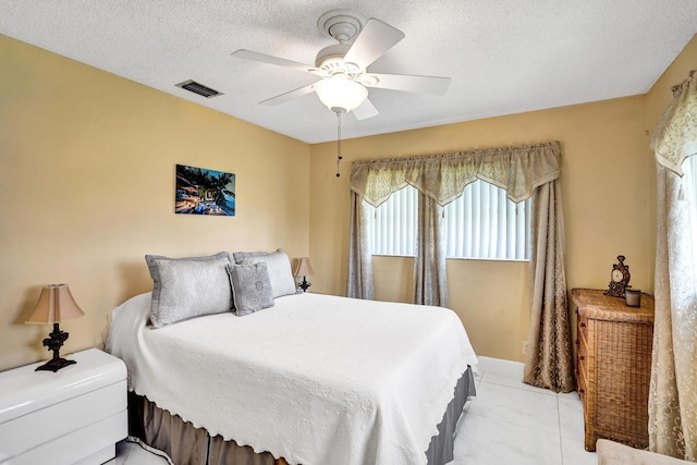 5730 Fernley Dr E Unit 15, West Palm Beach, FL 33415 - bedroom with marble finish floor, ceiling fan, visible vents, and a textured ceiling