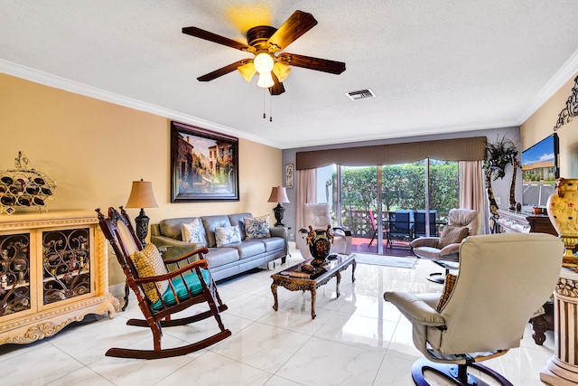living area with crown molding, a textured ceiling, ceiling fan, and visible vents
