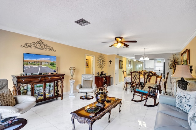 living room with ceiling fan with notable chandelier, marble finish floor, ornamental molding, a textured ceiling, and visible vents