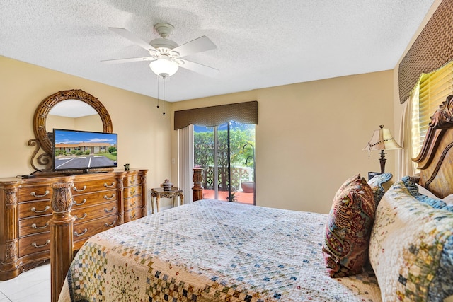 bedroom with a ceiling fan, a textured ceiling, and access to exterior