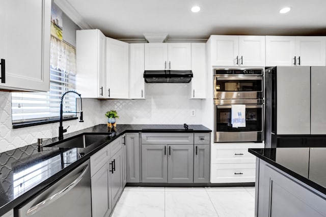 kitchen featuring a sink, under cabinet range hood, a healthy amount of sunlight, and appliances with stainless steel finishes