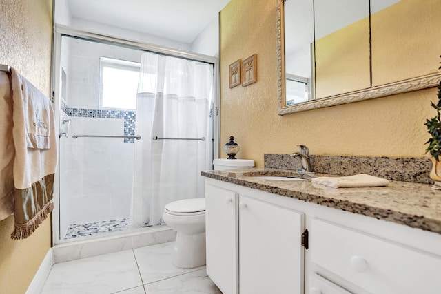 full bathroom featuring vanity, toilet, a textured wall, and a shower stall
