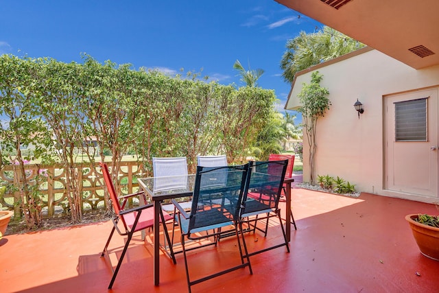 view of patio featuring outdoor dining area and visible vents