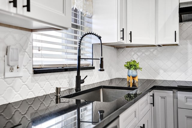 kitchen with white cabinetry, tasteful backsplash, and a sink