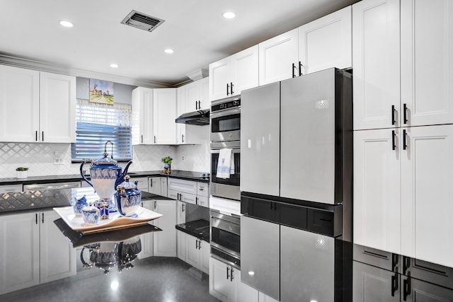 kitchen featuring tasteful backsplash, visible vents, recessed lighting, white cabinetry, and appliances with stainless steel finishes