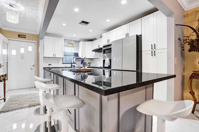 5730 Fernley Dr E Unit 15, West Palm Beach, FL 33415 - kitchen with tasteful backsplash, a kitchen breakfast bar, visible vents, recessed lighting, and dark countertops