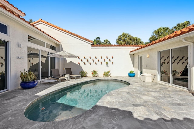 outdoor pool with a patio area