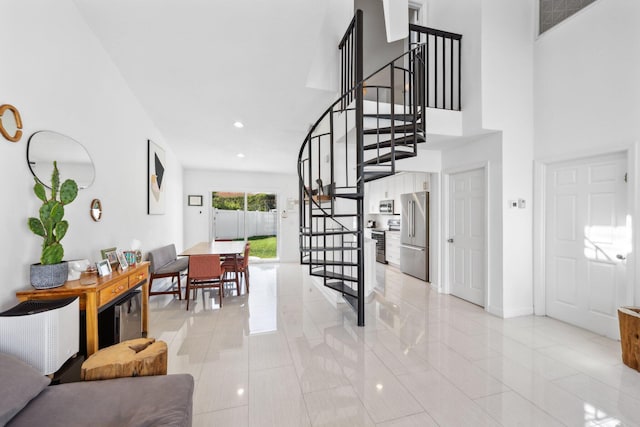 entrance foyer featuring light tile patterned flooring, baseboards, recessed lighting, and stairway