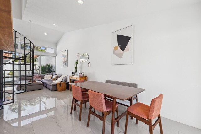 dining room with recessed lighting, vaulted ceiling, and stairway